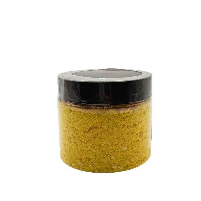 Jar of yellow powder egg scramble with a black lid on a white background
